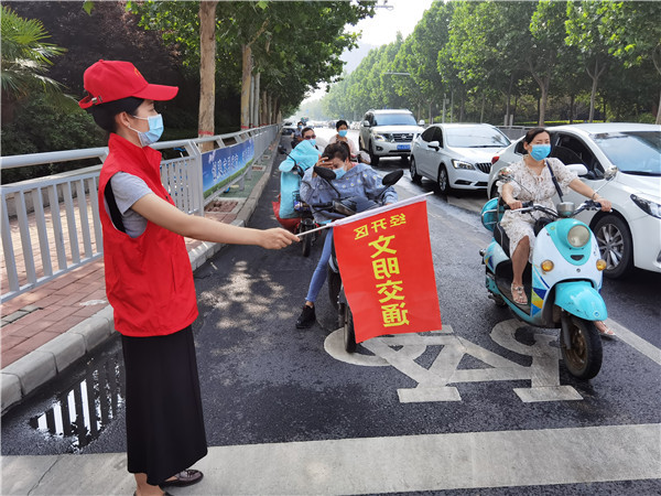 教师志愿者开展以"为文明助力,为城市添彩"为主题的交通志愿服务活动