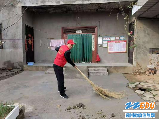 总务主任高中亮帮助村民打扫院子卫生