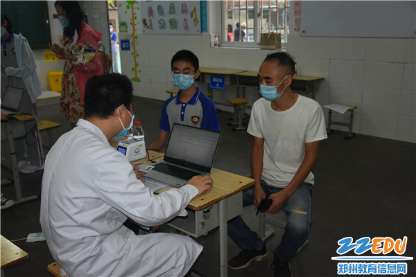 3.郑州42中学生在疫苗接种点登记区登记个人信息