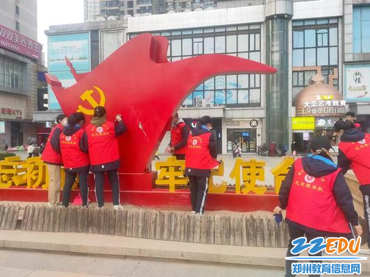 志愿者细心擦拭雕塑 志愿者细心擦拭雕塑