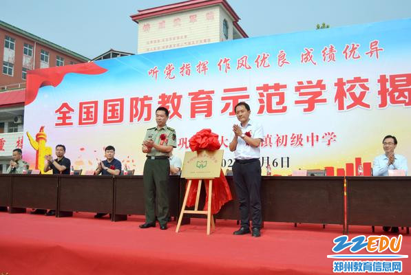 2023年9月6日巩义市大峪沟镇初级中学举行“全国国防教育示范学校”揭牌仪式上巩义市武装部政委李强和巩义市教育局党组书记、局长杨少辉揭牌2